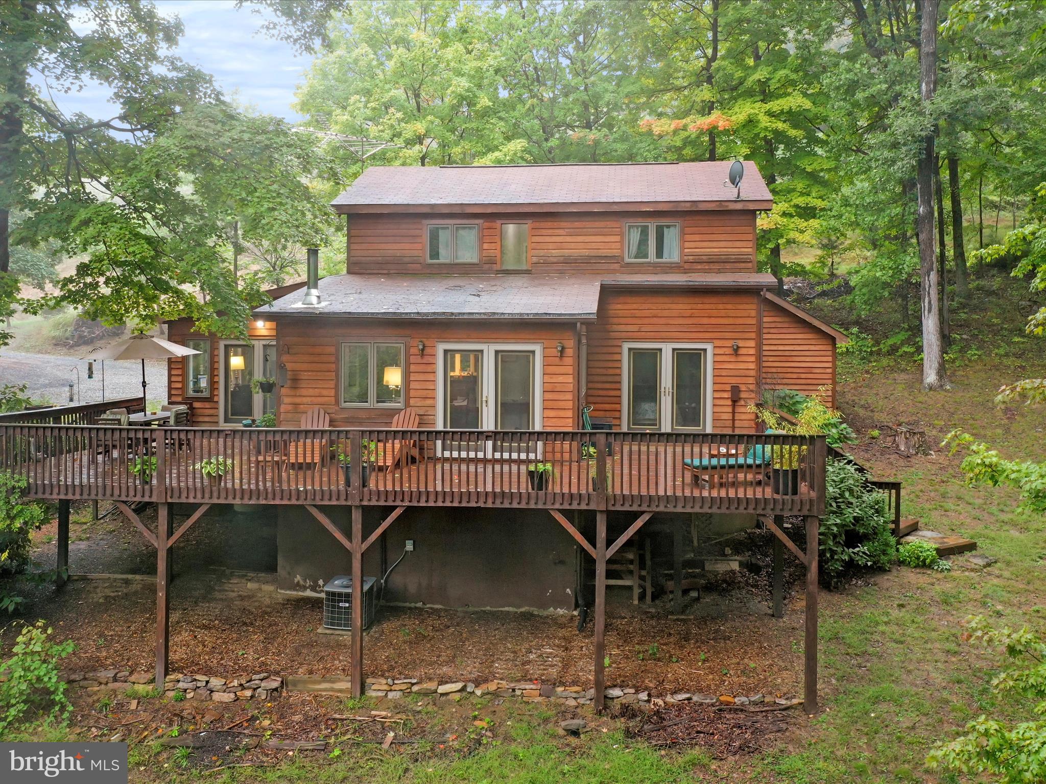 a view of a house with backyard porch and sitting area