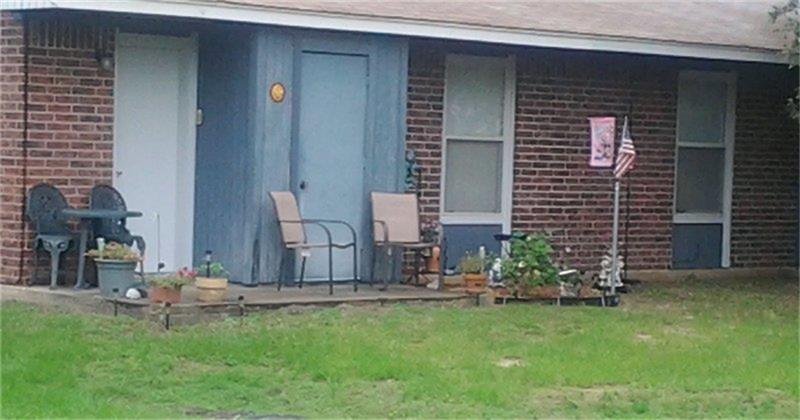 a backyard of a house with table and chairs