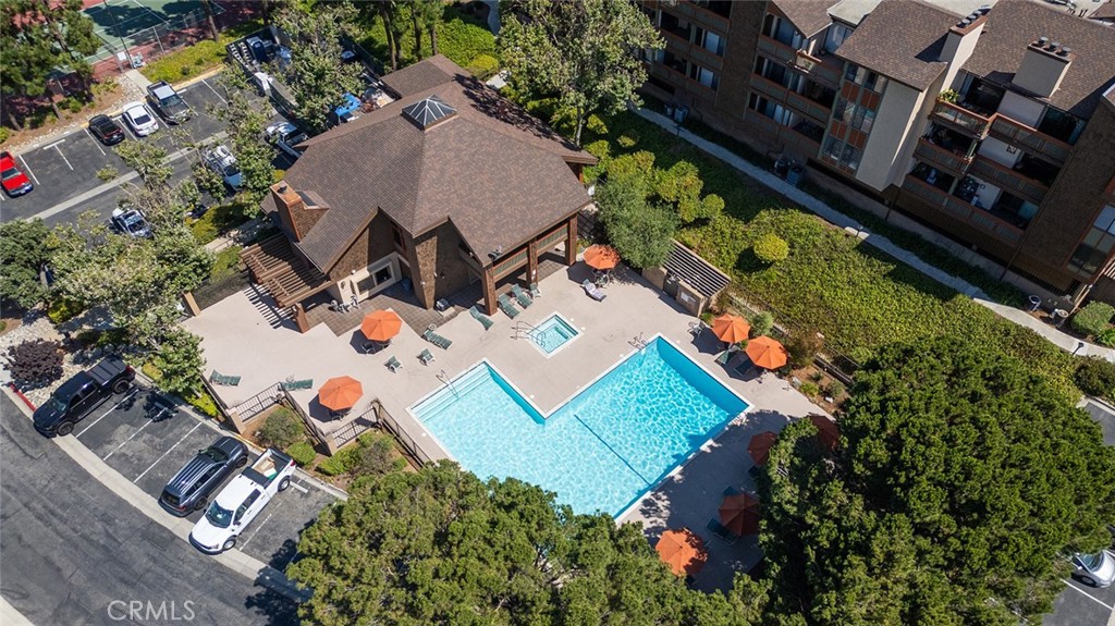 an aerial view of a house with a garden and swimming pool