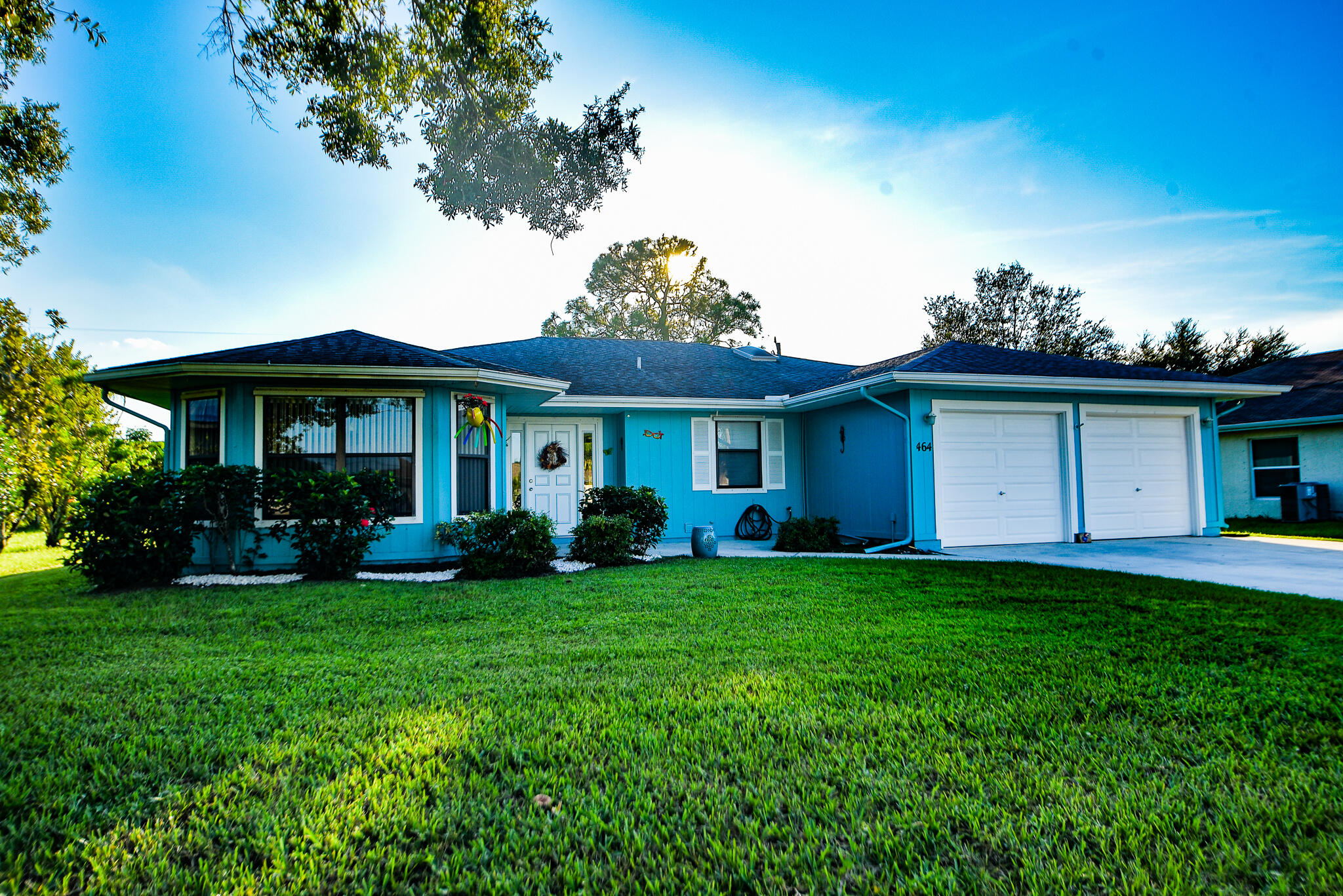 a front view of a house with a garden