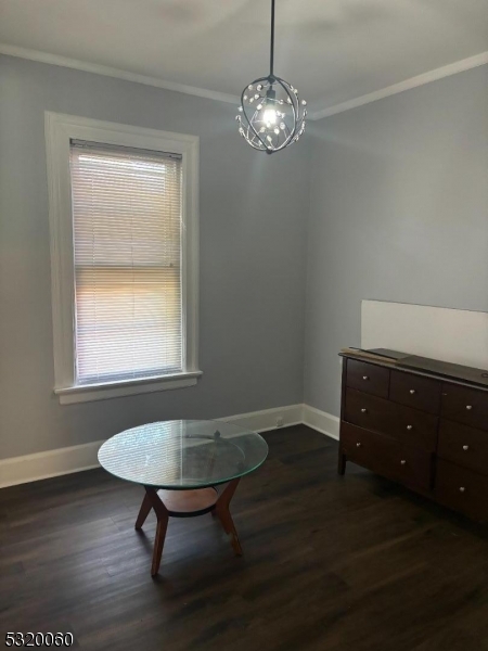 a room with wooden floor a table and chair