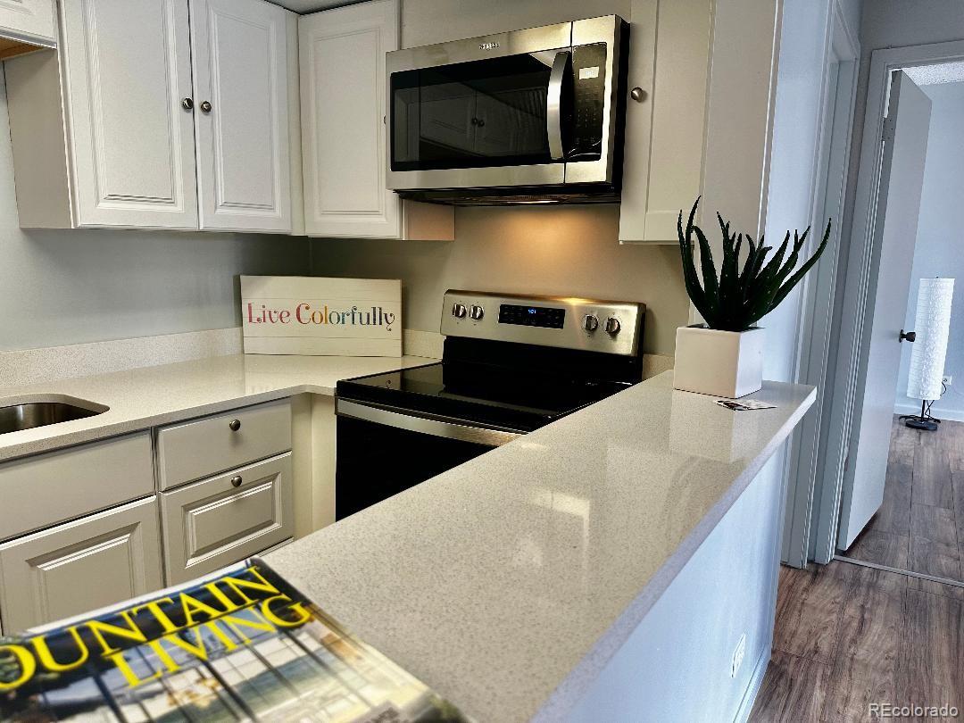 a kitchen with stainless steel appliances a stove a microwave and cabinets