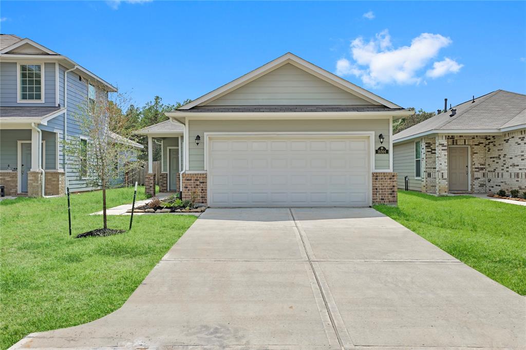 a front view of a house with a yard and porch