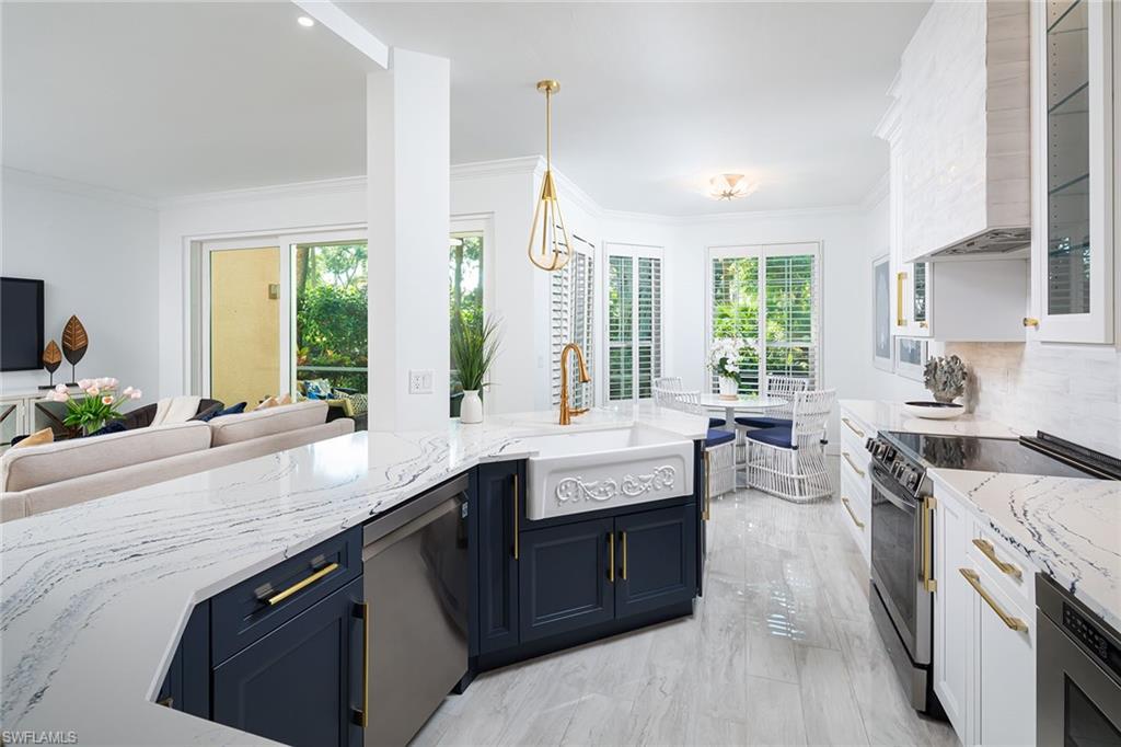 a large kitchen with granite countertop a sink and a stove