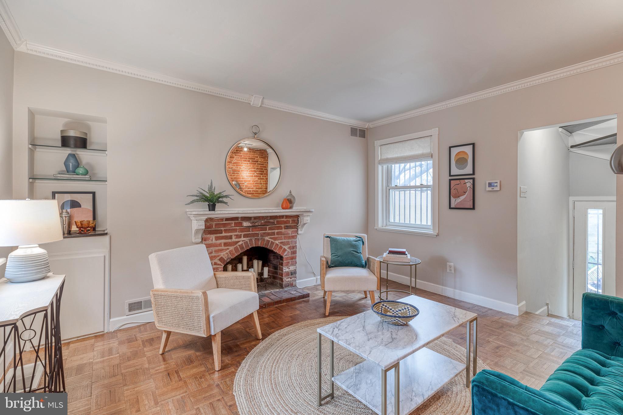 a living room with furniture a rug and a fireplace