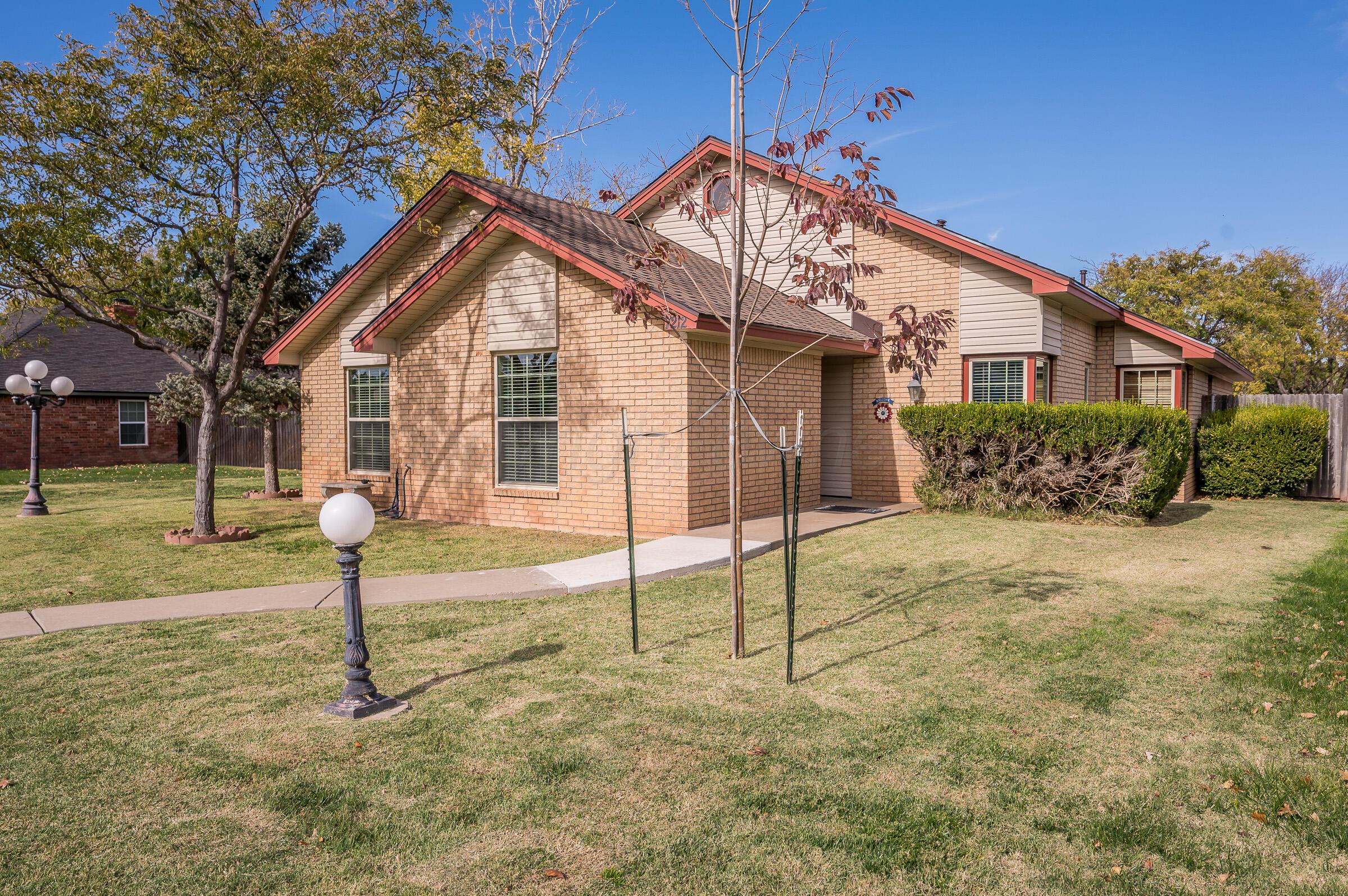 a view of a house with a yard