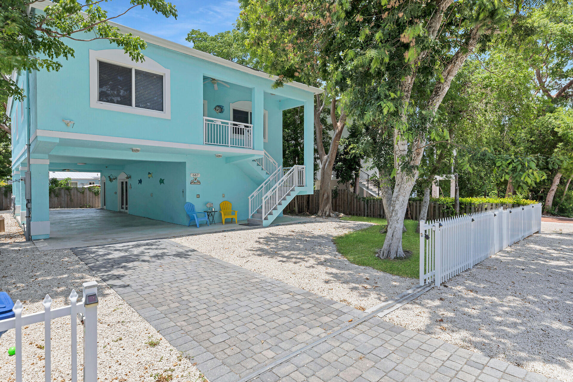 a view of a house with backyard and a tree