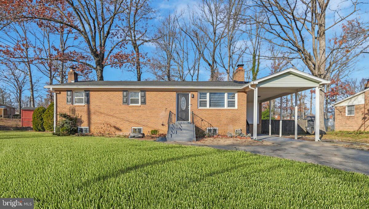 a front view of a house with yard and green space