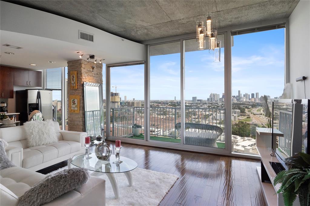 a living room with furniture and a floor to ceiling window