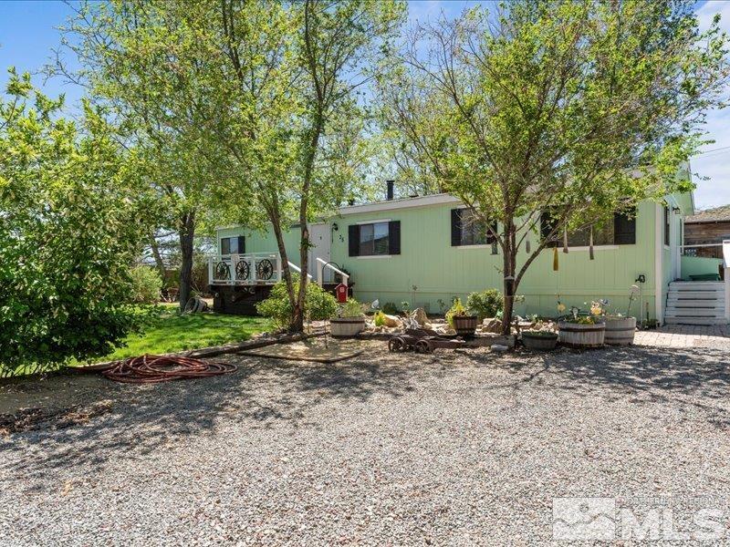 a backyard of a house with plants and tree