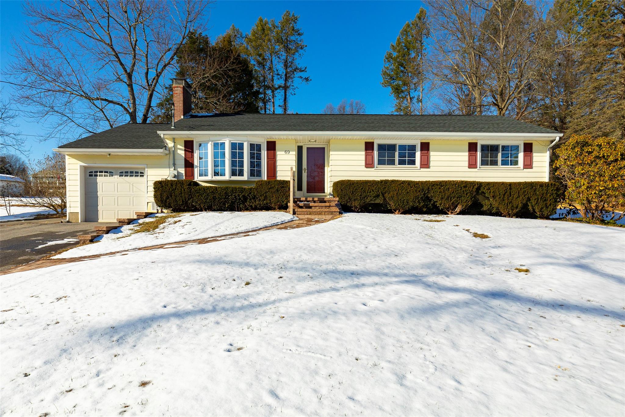 a view of house with snow on the road