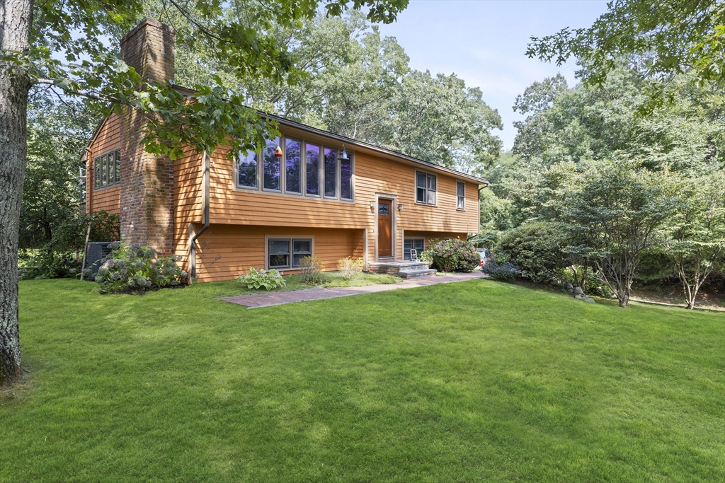 a front view of house with yard and seating area