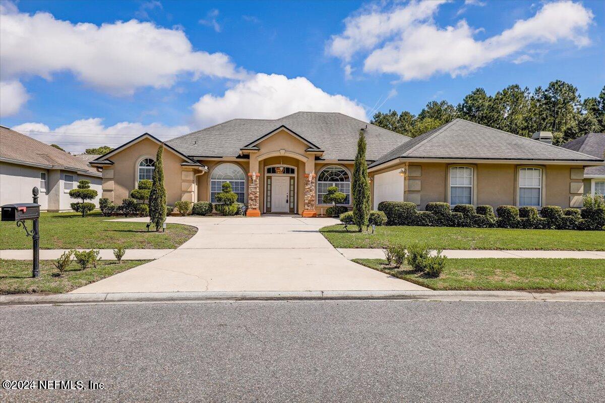 a front view of a house with a yard