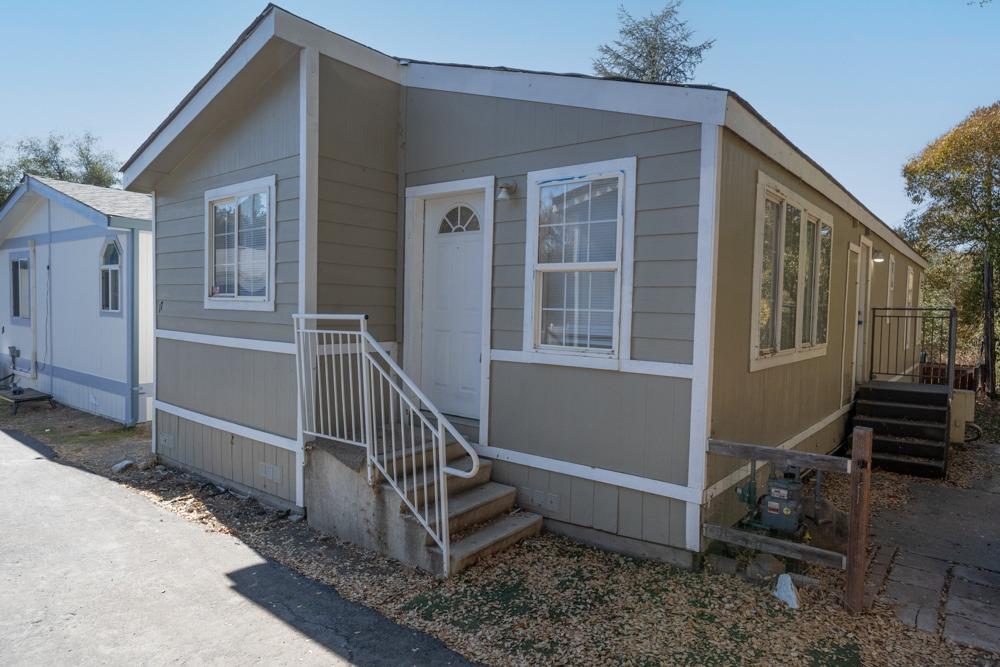 a view of a house with backyard and deck