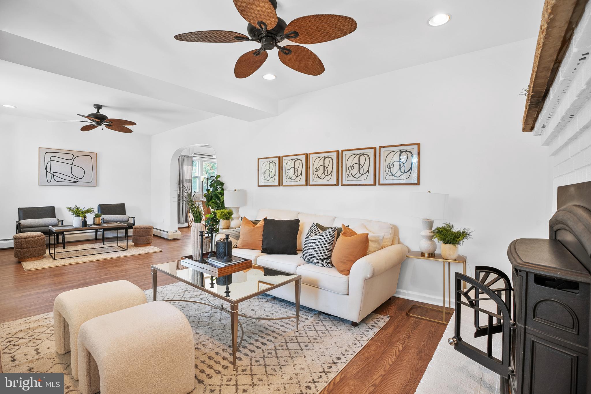 a living room with furniture and a ceiling fan