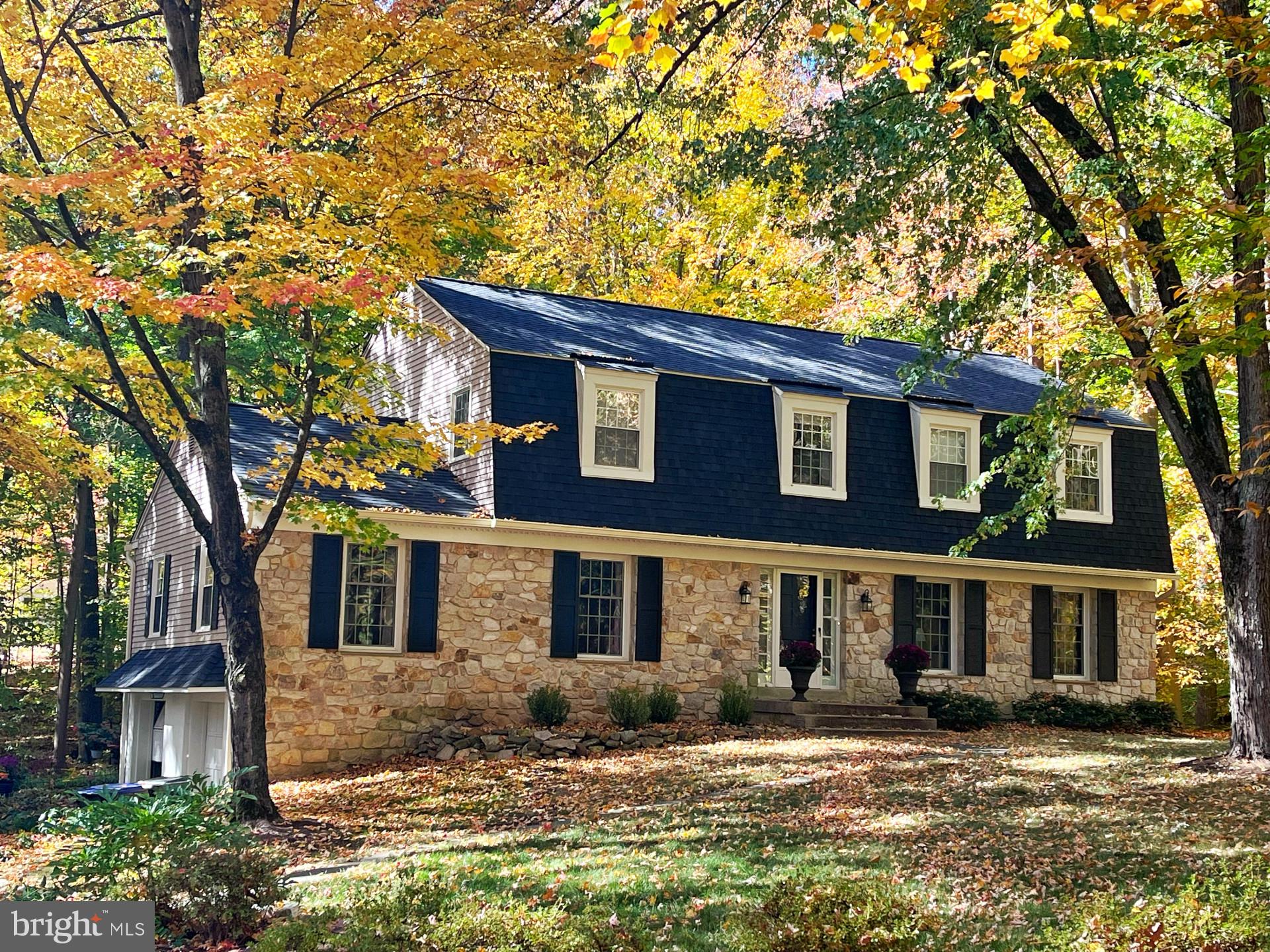 a view of a brick house with a large windows and a big tree