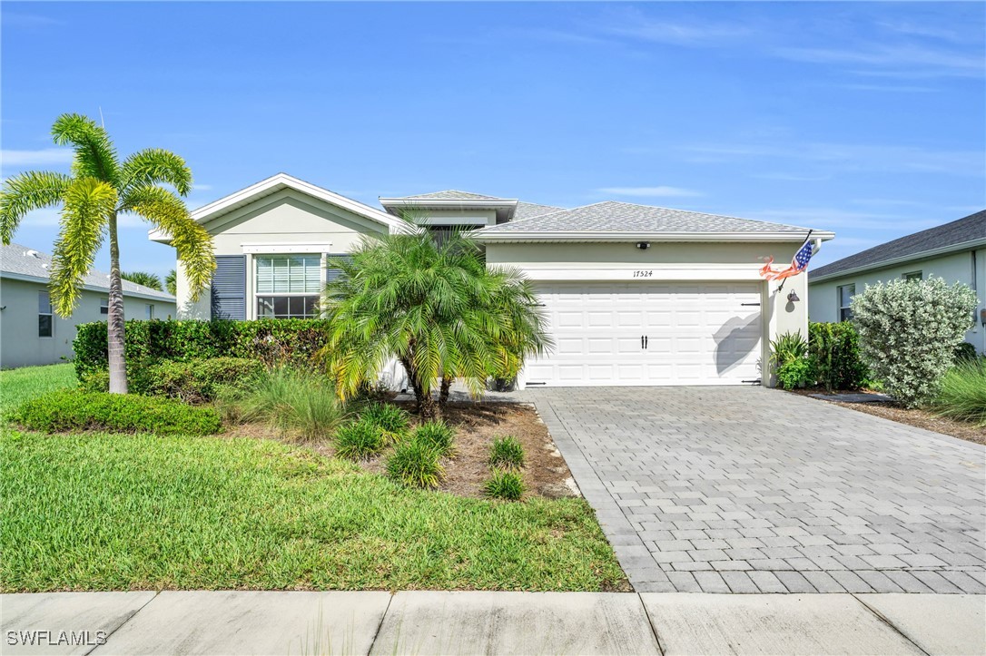 a front view of a house with a yard and garage