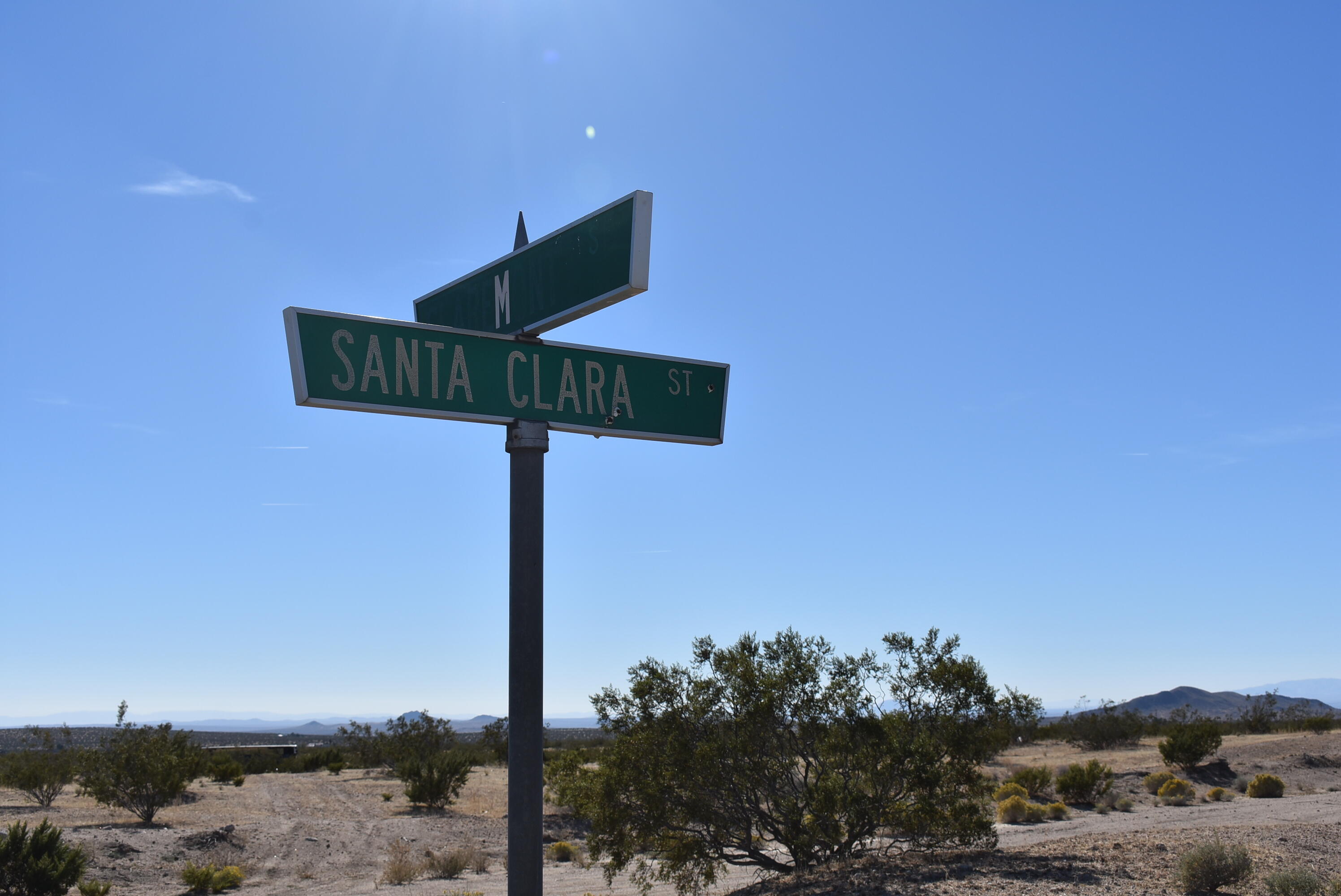 a street sign on a pole next to a road