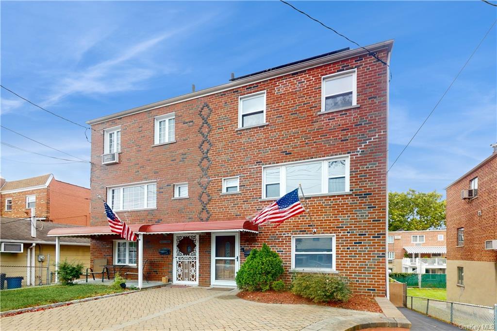 a front view of a residential apartment building with a yard