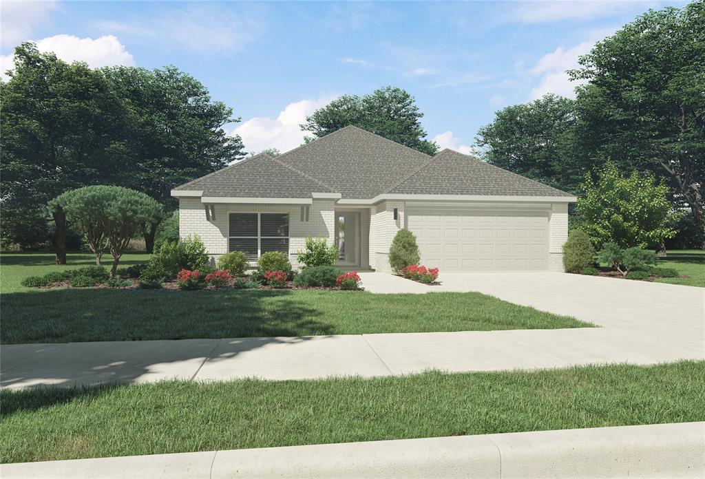 a front view of a house with a yard and trees