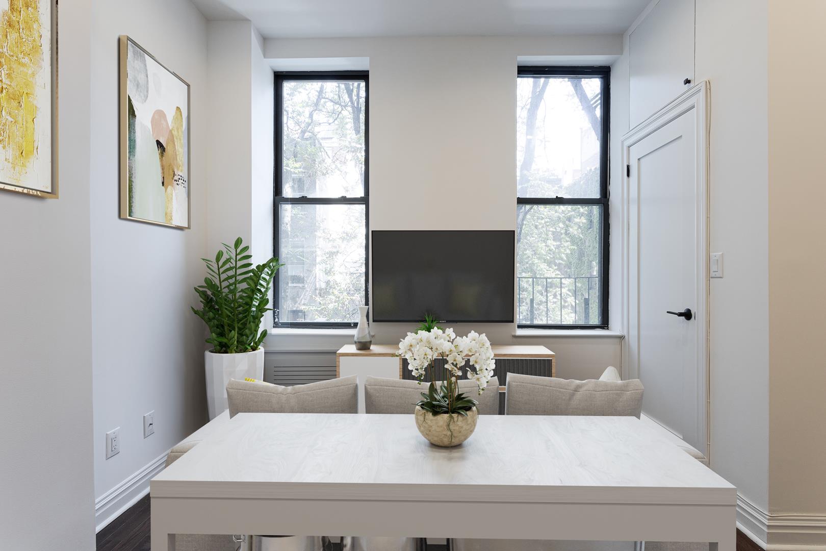 a living room with furniture and a potted plant