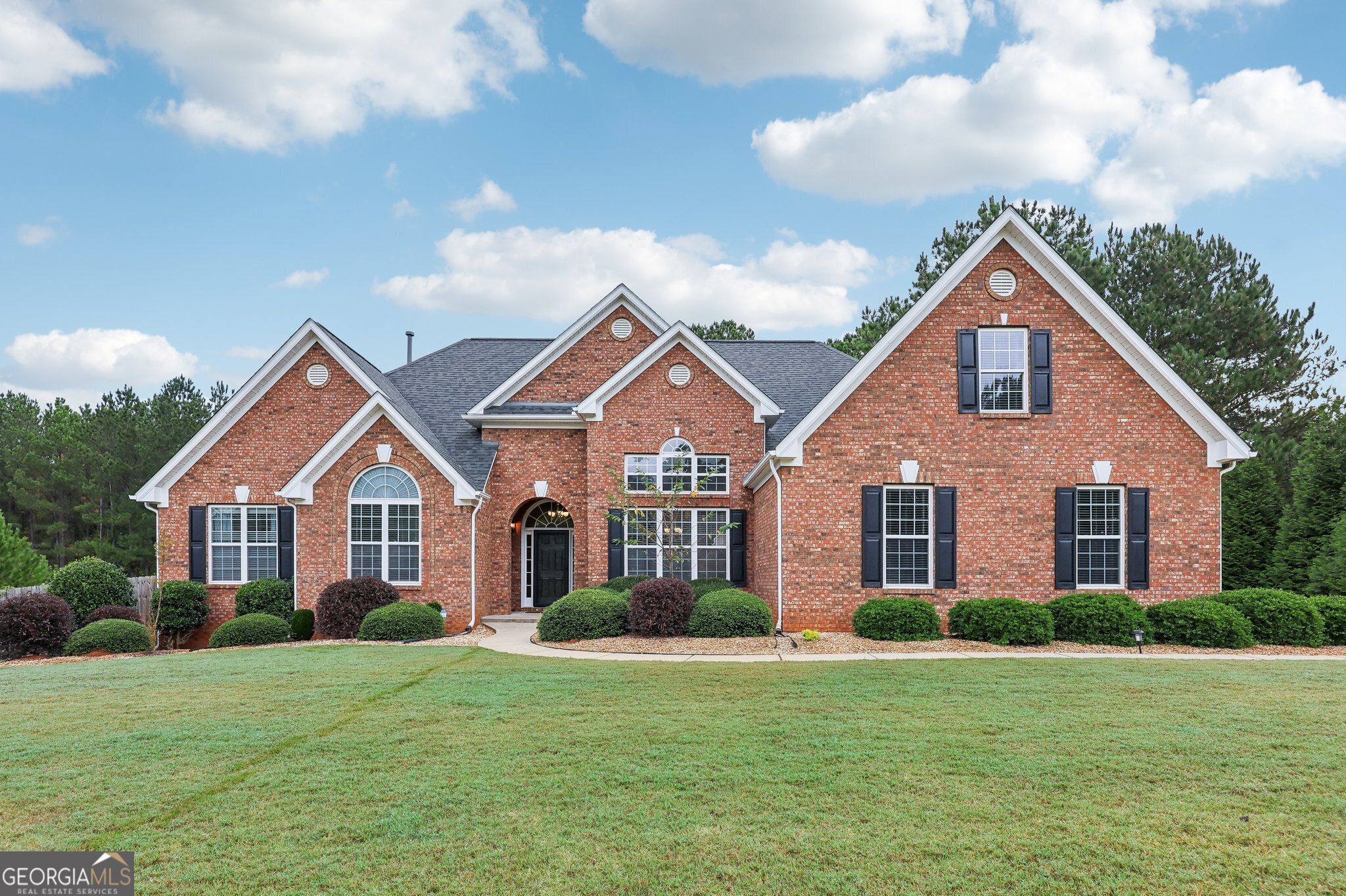 a front view of a house with a yard