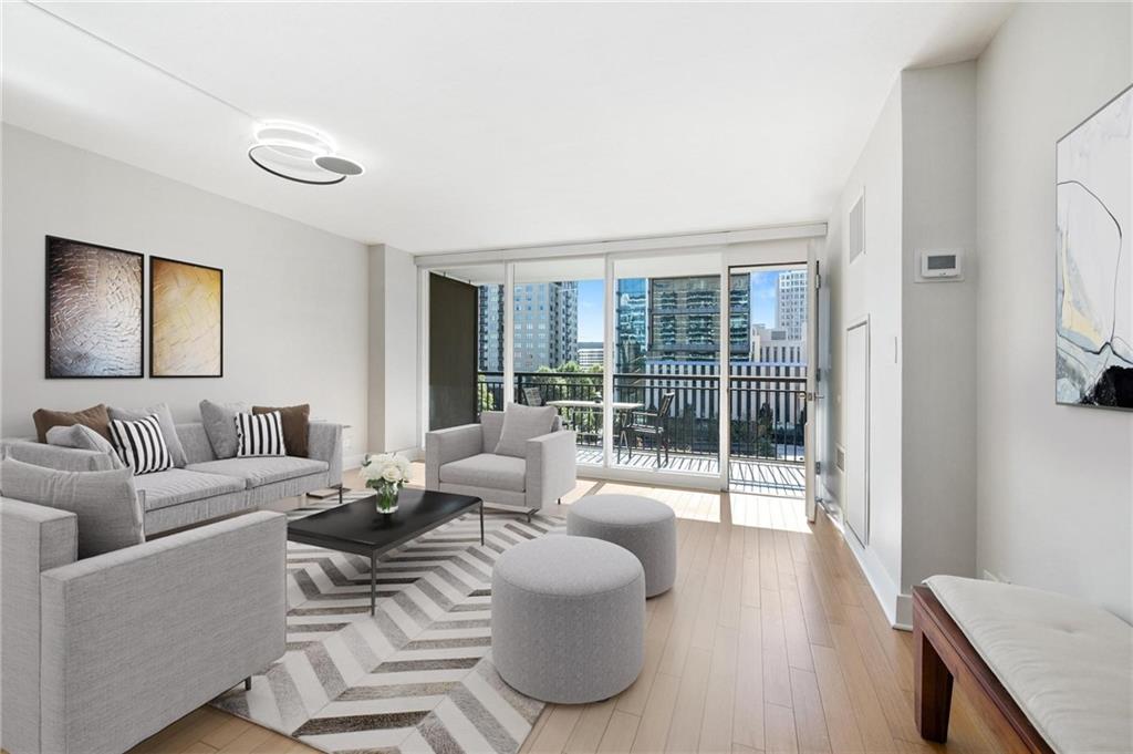 a living room with furniture and a floor to ceiling window