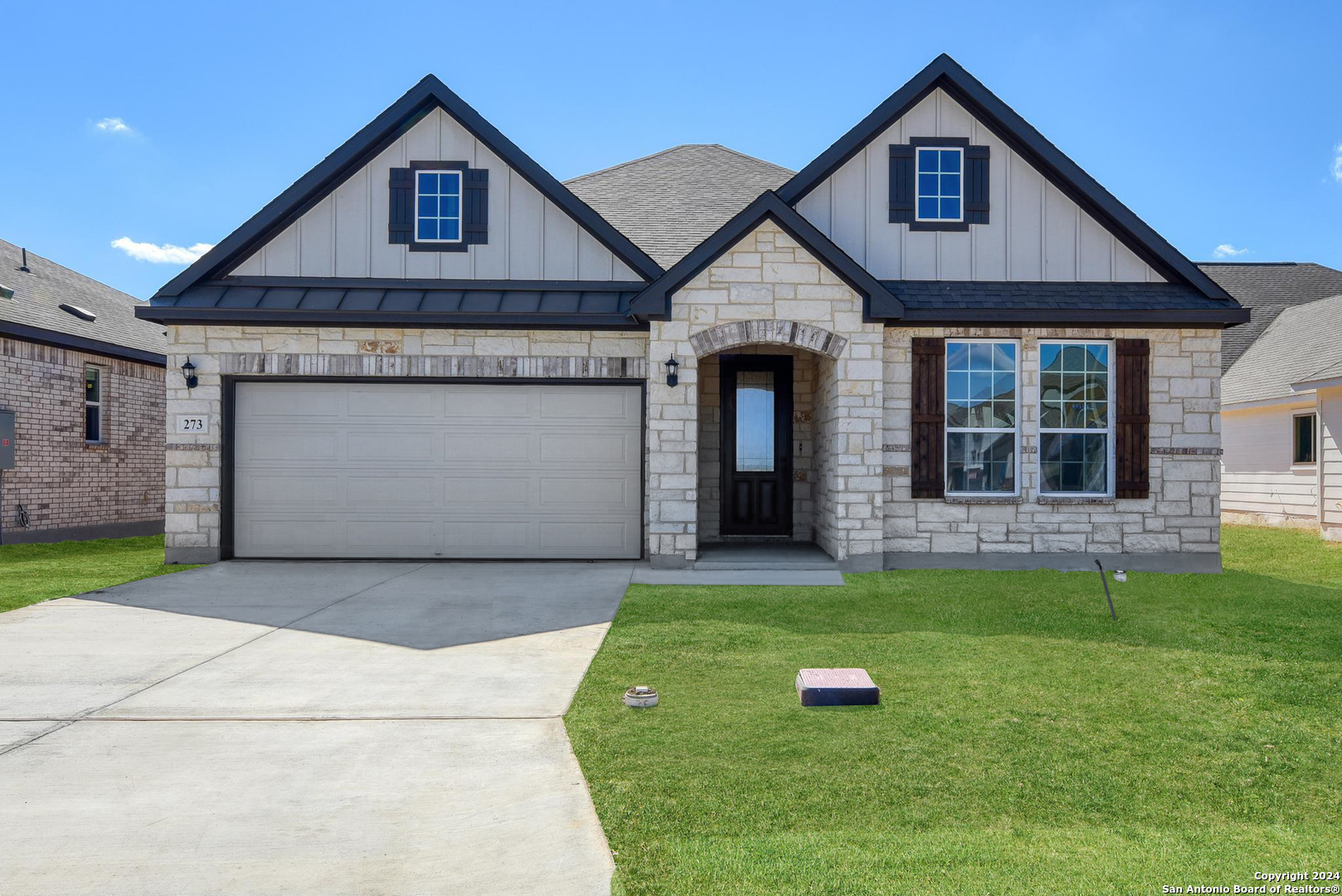 a front view of a house with a yard and garage