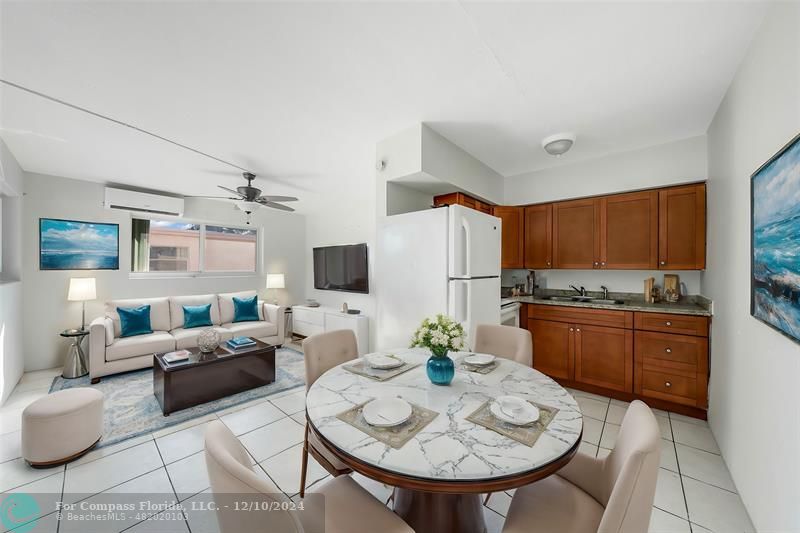 a living room with furniture and a kitchen view