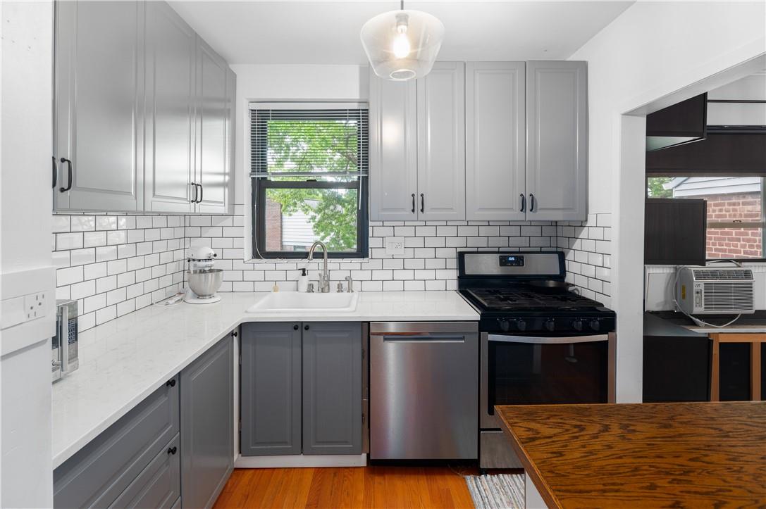 a kitchen with stainless steel appliances a sink stove and cabinets