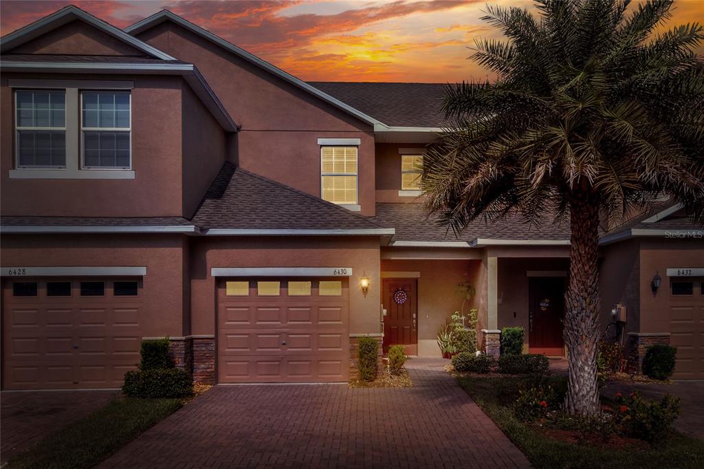 a front view of a house with yard