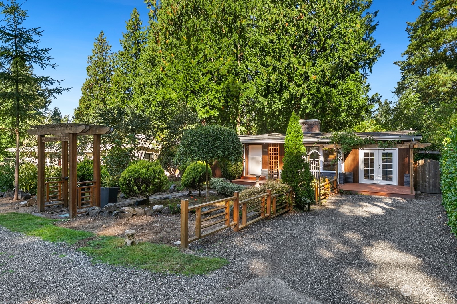 a view of a house with backyard sitting area and garden