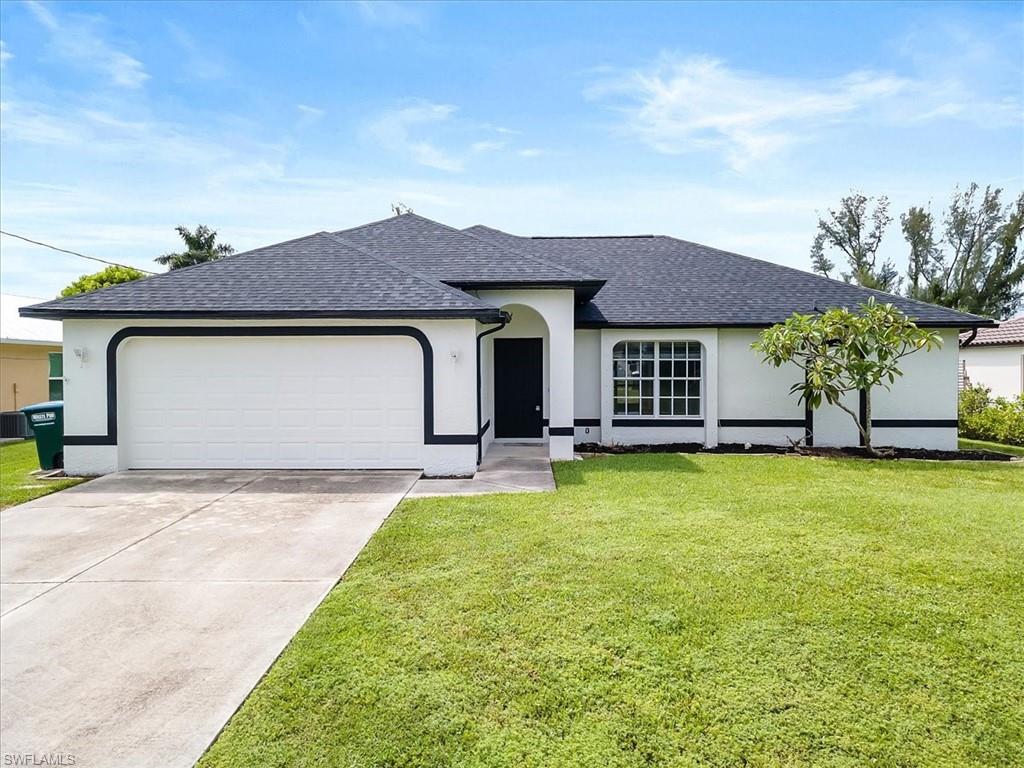 Ranch-style house with a front lawn and a garage