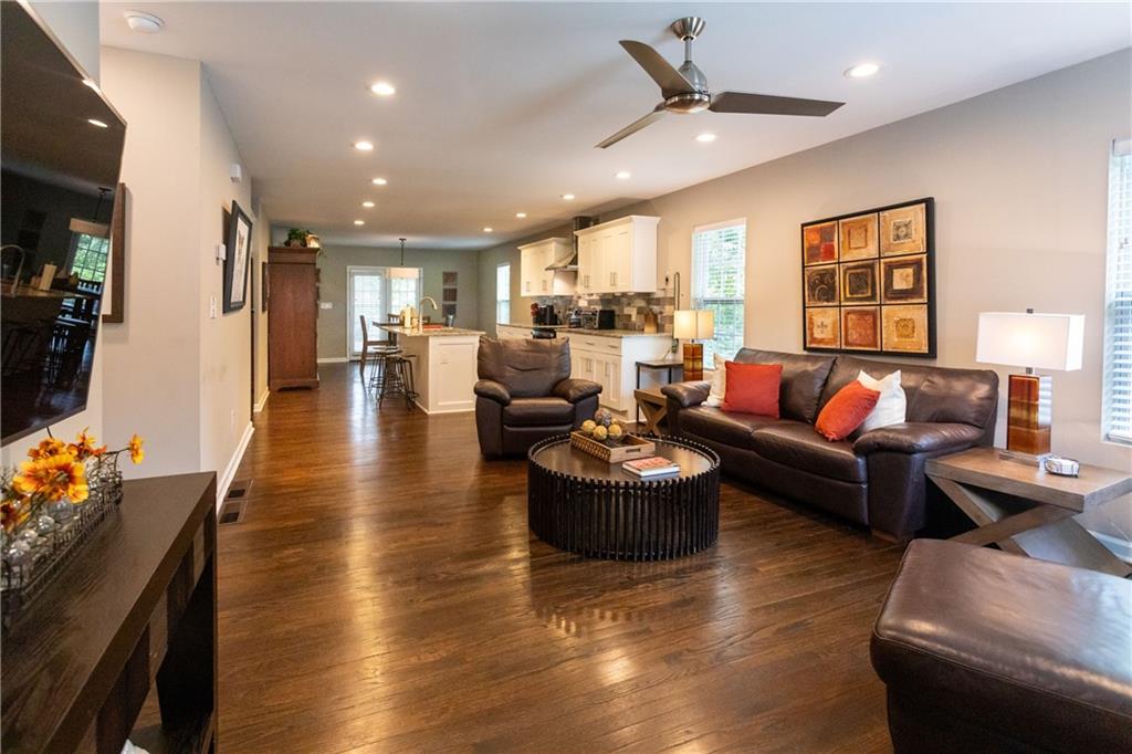 a living room with furniture and kitchen view