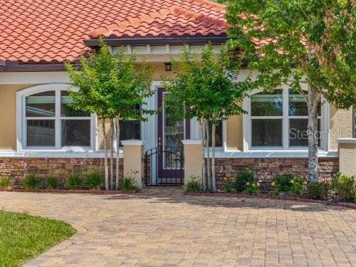 a front view of a house with a garden