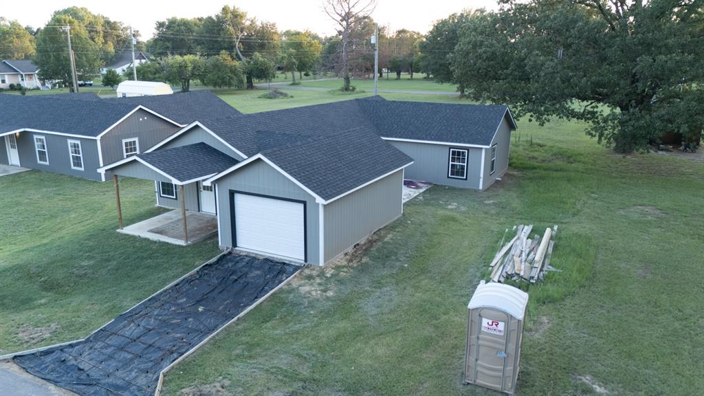 a aerial view of a house with a yard