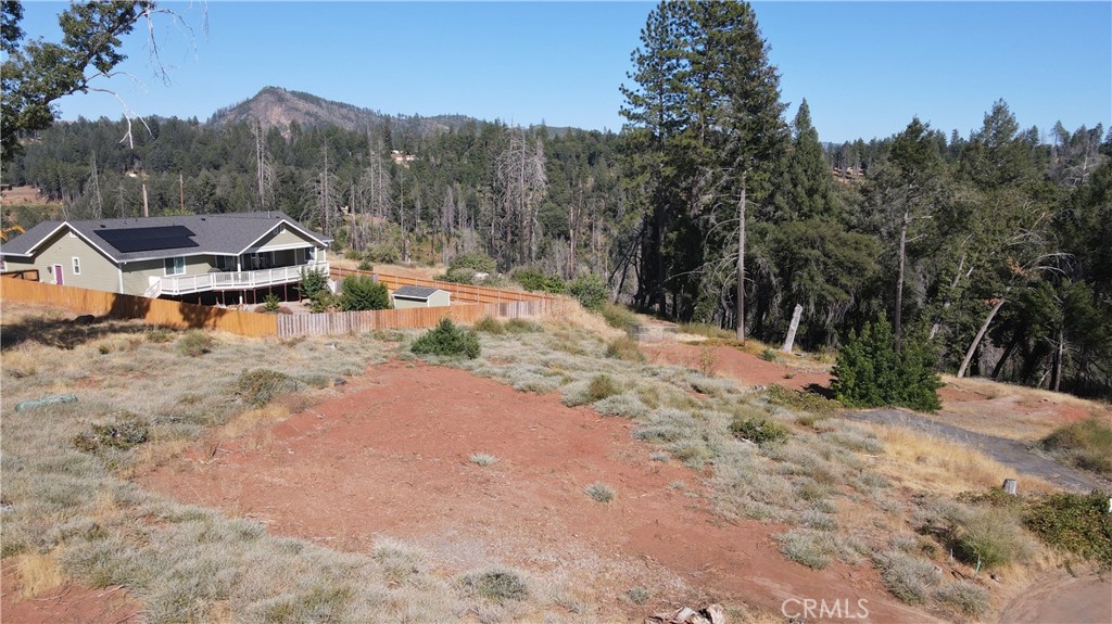 a view of a dirt road with a building in the background