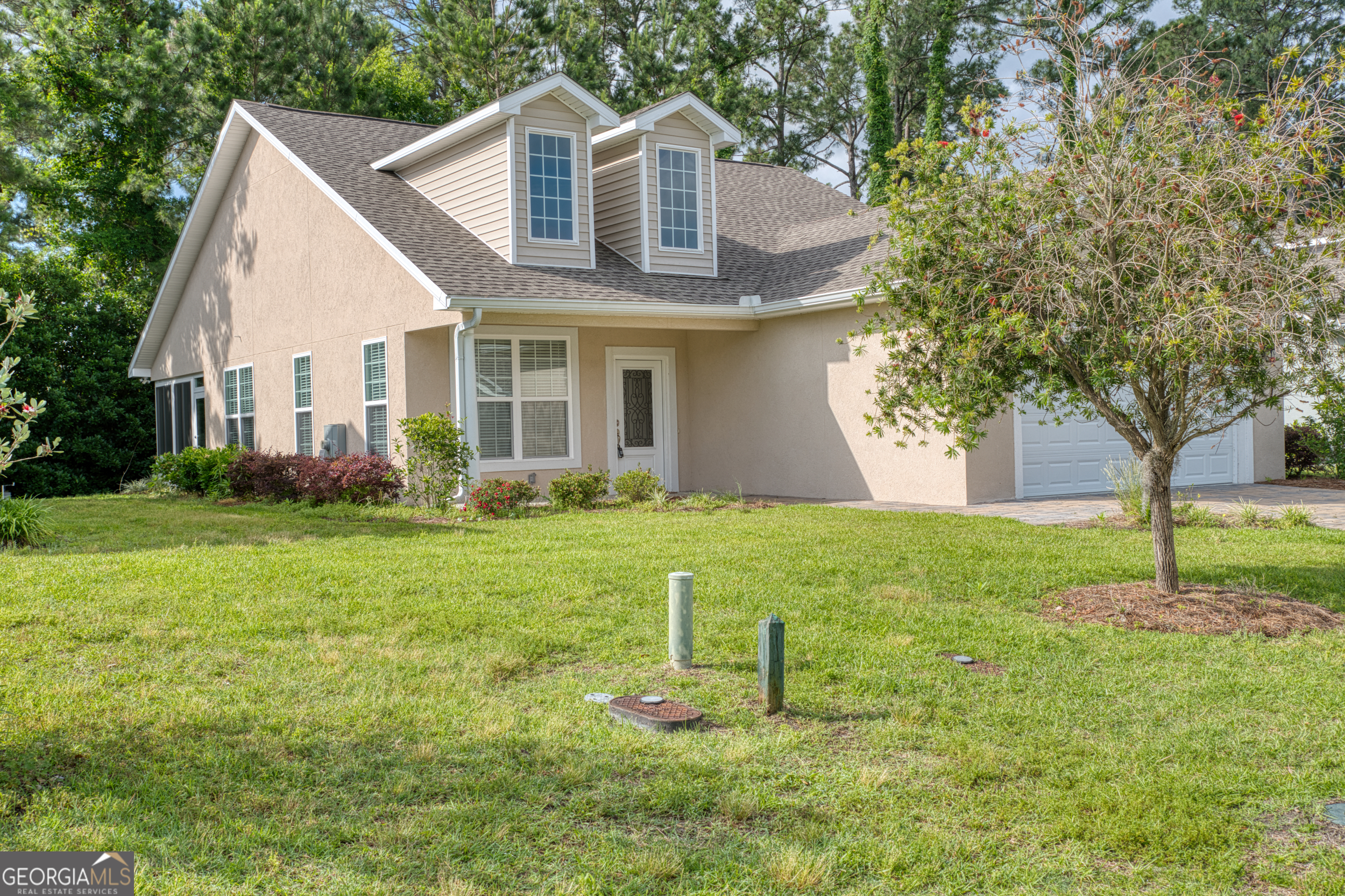 a front view of a house with garden