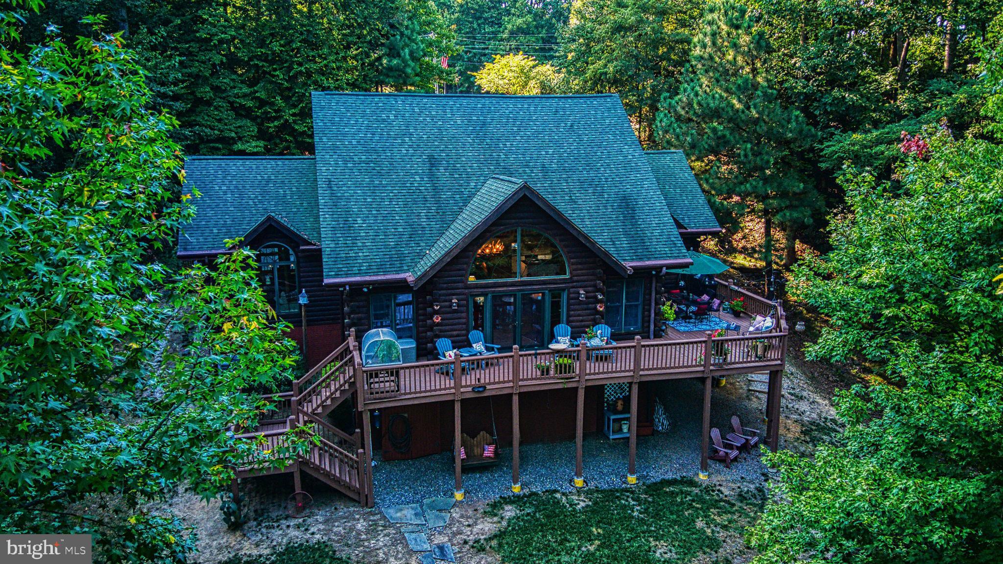 a view of house with roof deck and entertaining space