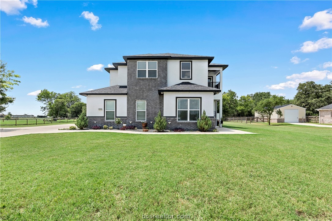 a front view of house with yard outdoor seating and green space