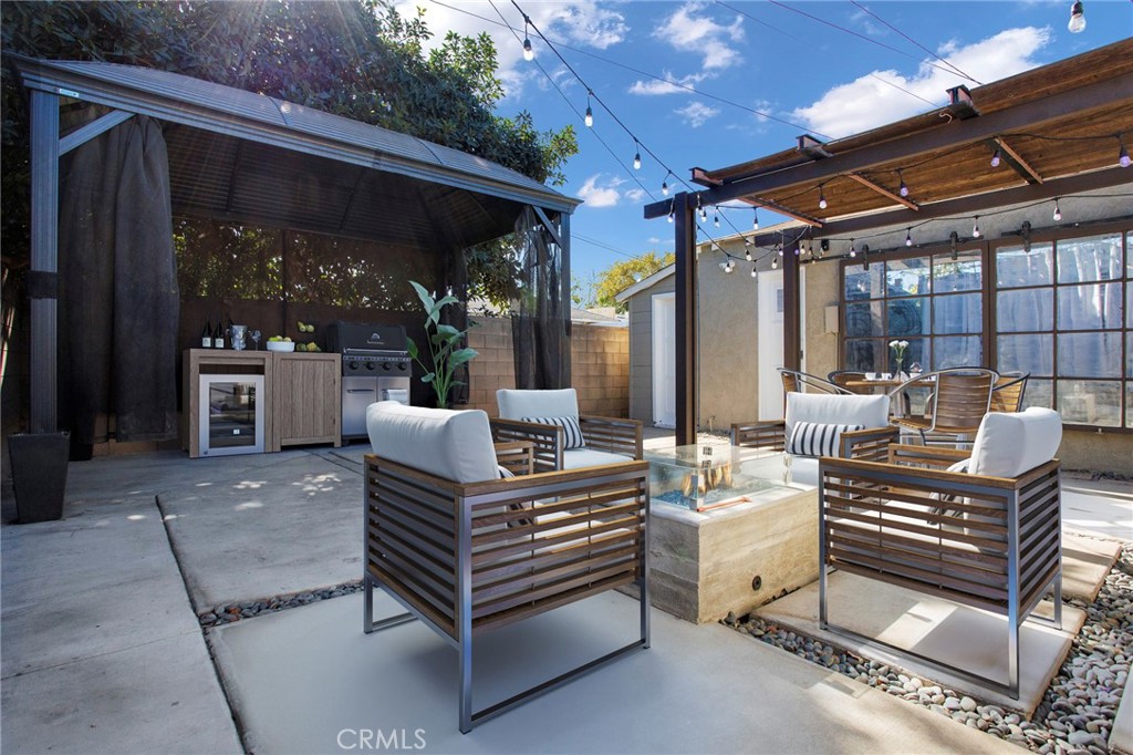 a view of a patio with table and chairs potted plants with wooden floor