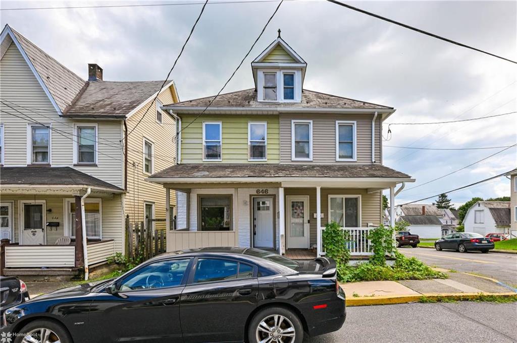 a front view of a house with parking space