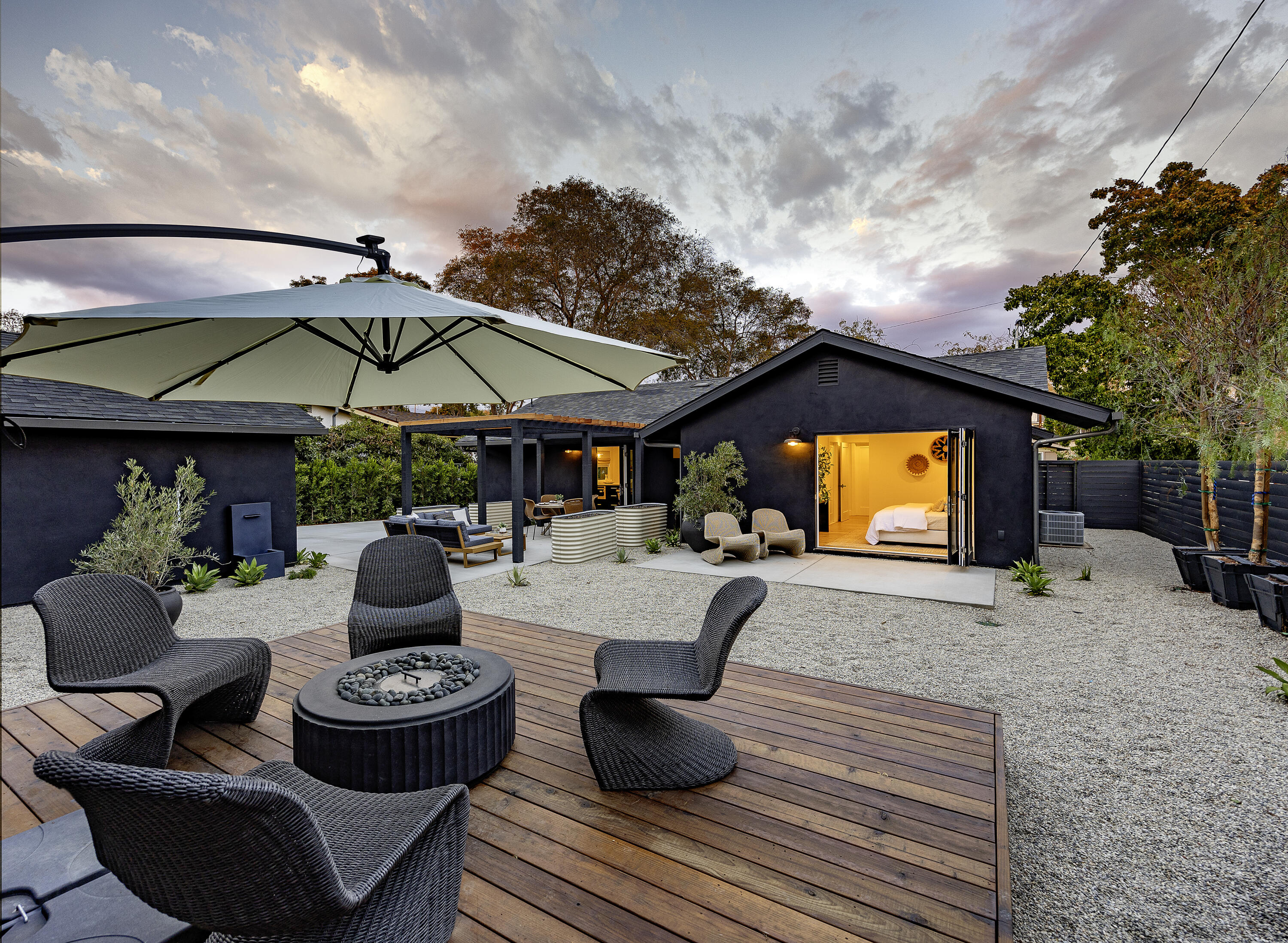 a outdoor living space with furniture and umbrella