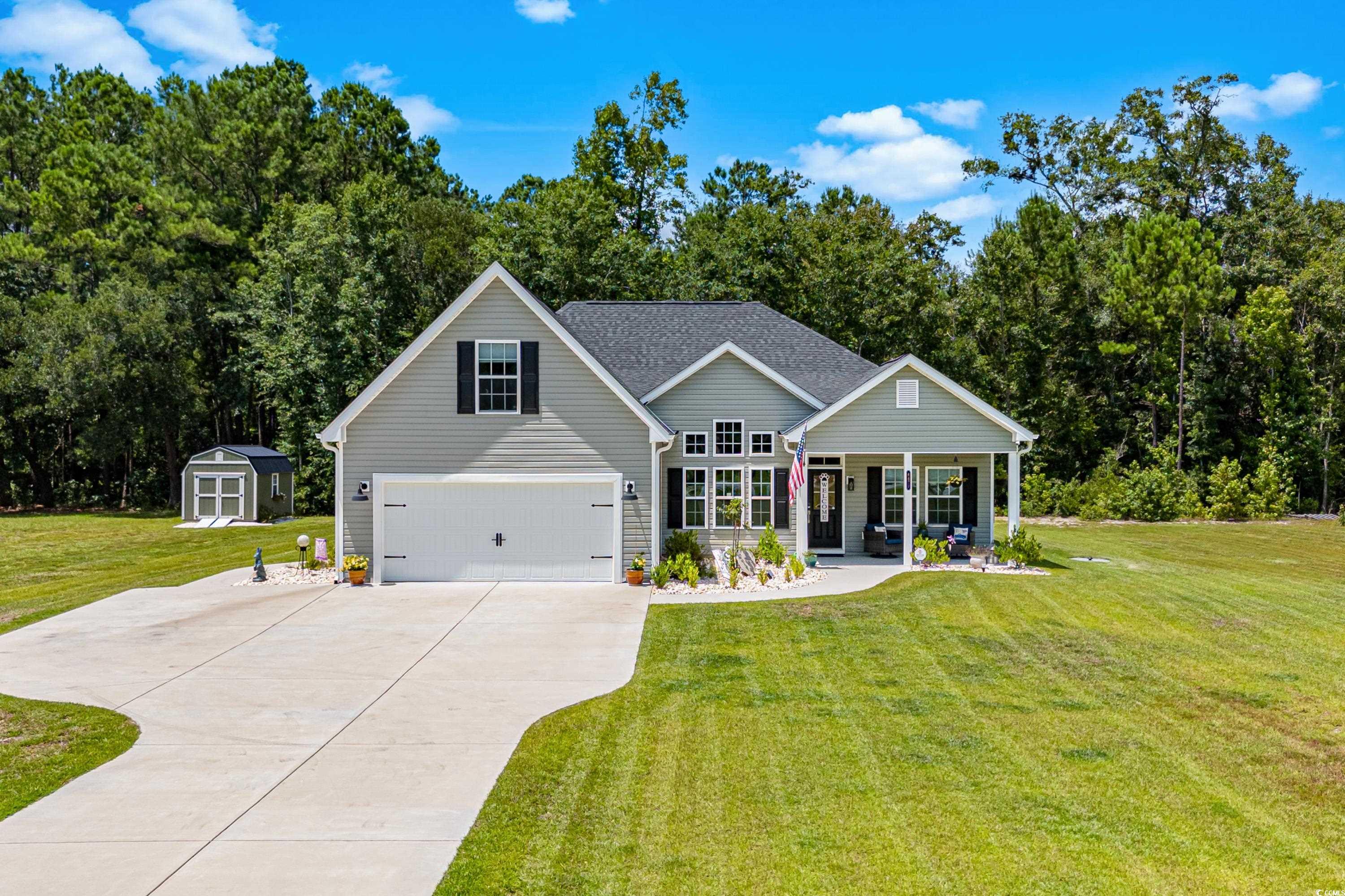 View of front facade featuring a garage and a fron