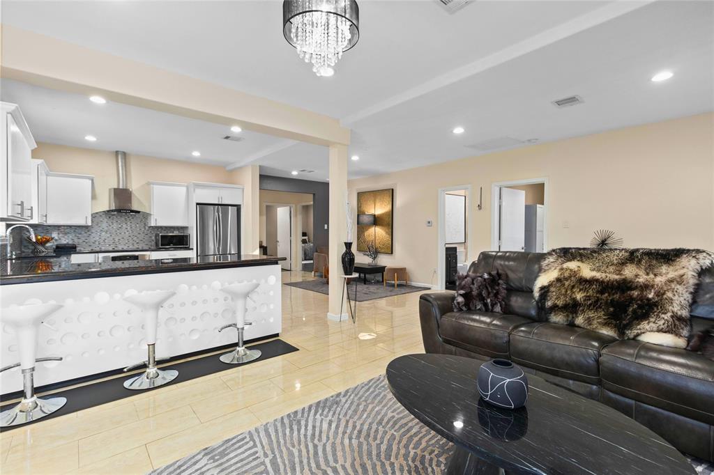 a living room with furniture and kitchen view