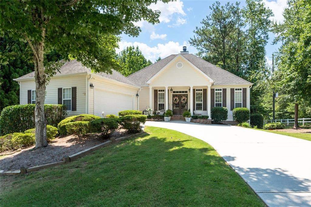 a front view of a house with a garden and porch