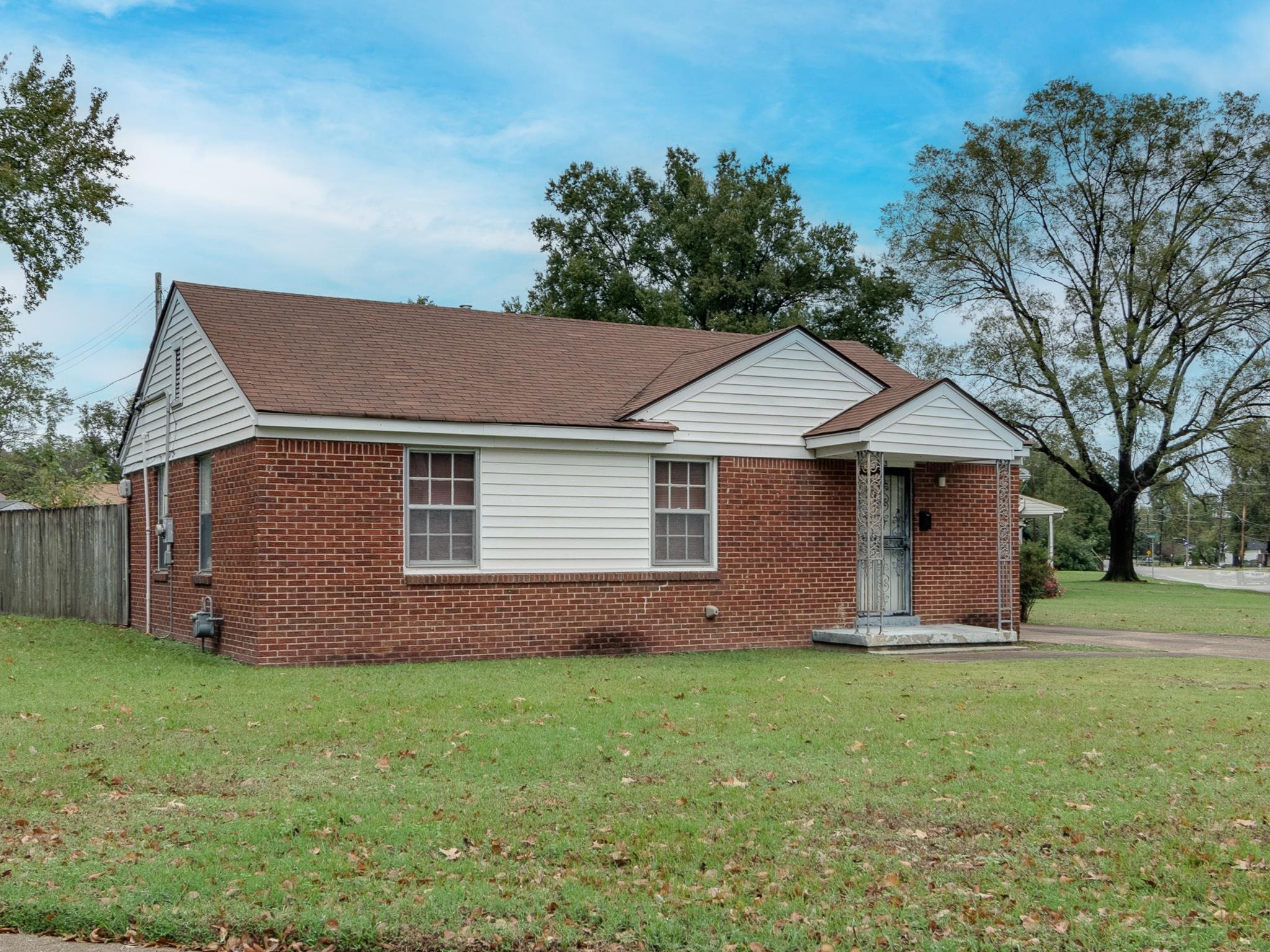 a front view of house with yard and green space