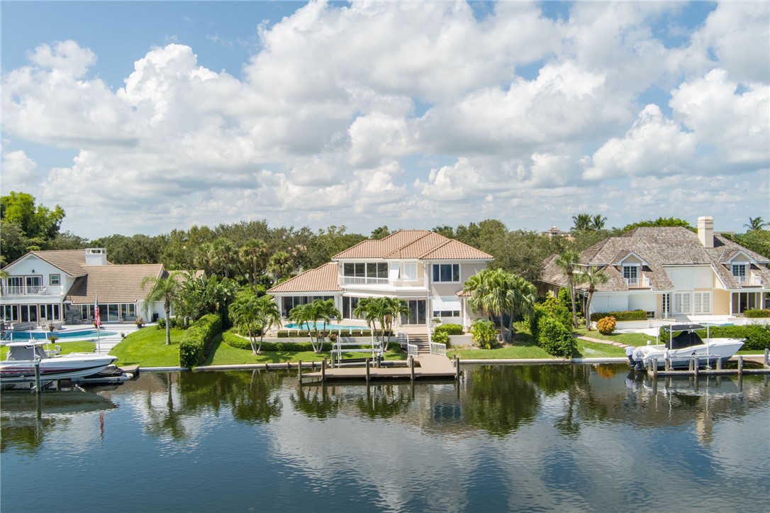 a view of house with yard and lake view