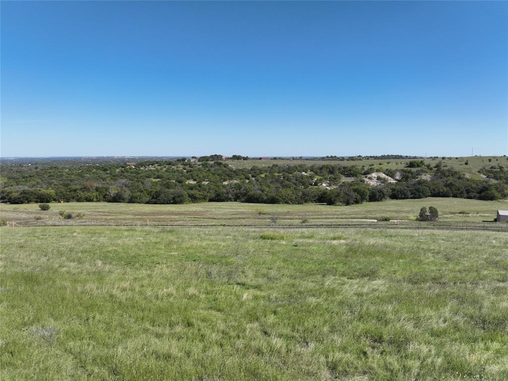 a view of a field with ocean view