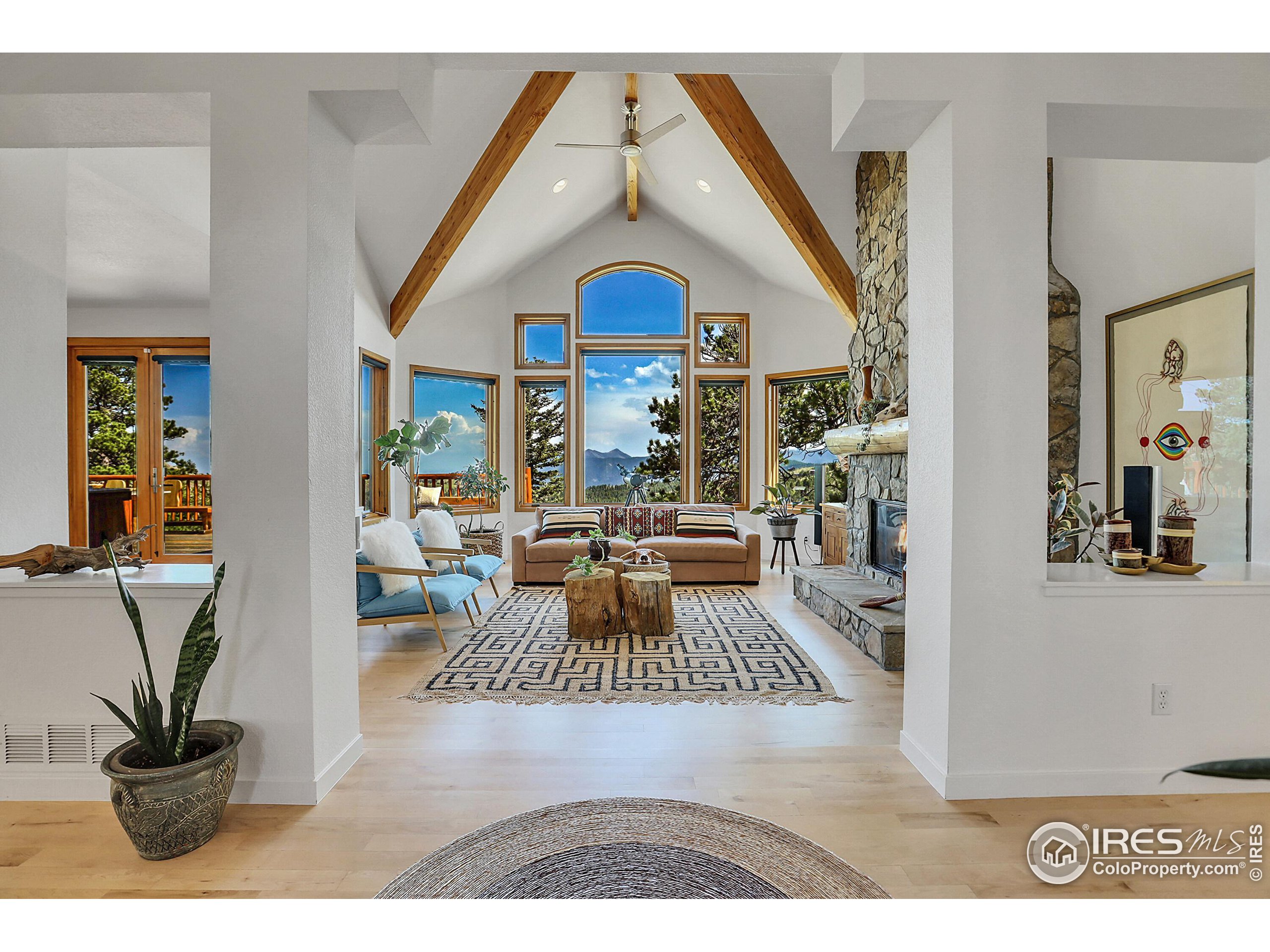 a living room with furniture a rug and a chandelier